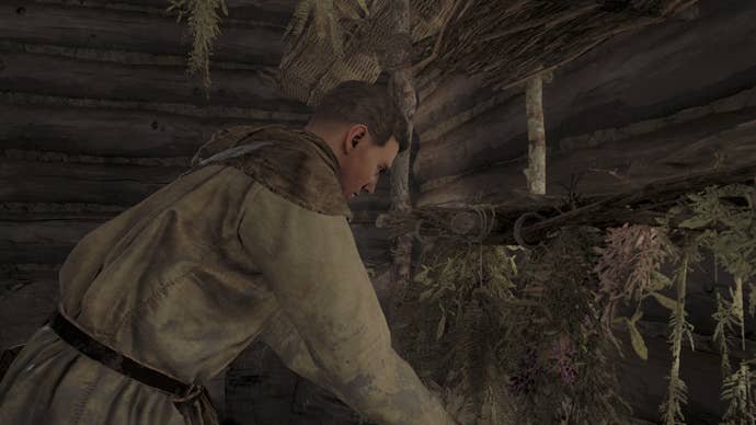 Henry placing herbs on a drying rack in Kingdom Come Deliverance 2