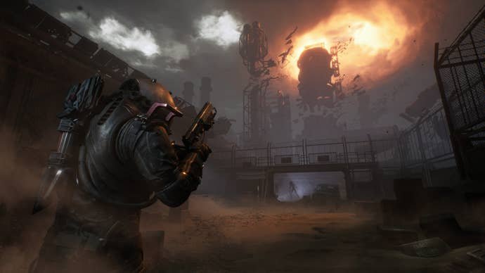 A heavily armoured man approached some sort of airborne anomaly, glowing overhead. He is holding a pistol.